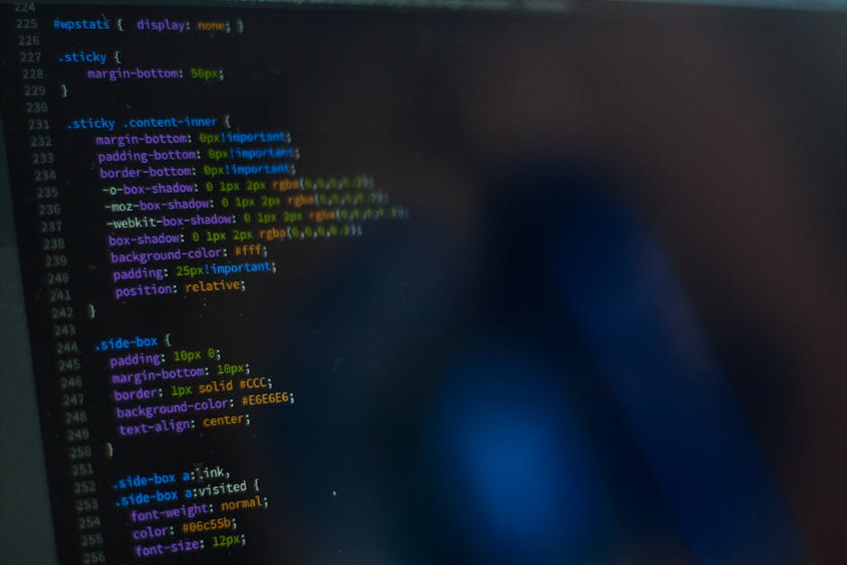A computer screen displaying lines of colorful programming code in various colors such as purple, blue, yellow, and red, with syntax highlighting on a dark background. The code includes functions, var